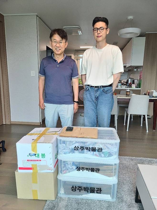 기증할 고서를 박스에 담은 후 학예사와 기념 촬영하는 작가ⓒ