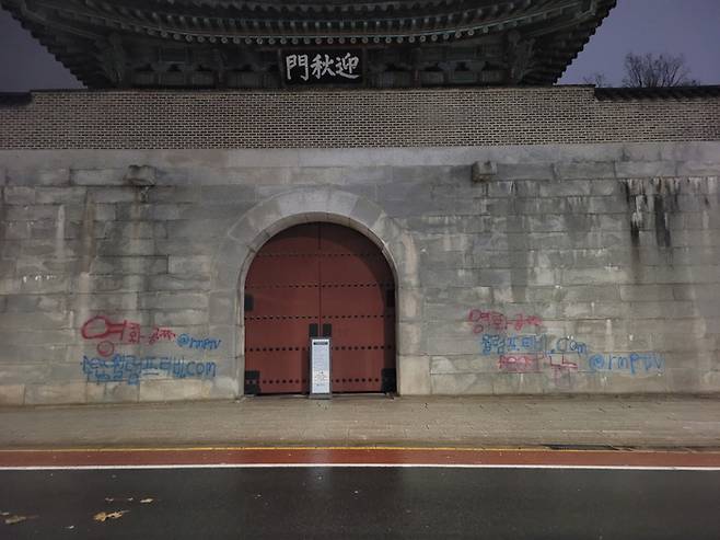 지난 16일 새벽 신원미상의 행인이 경복궁 영추문 좌우쪽에 ‘영화공짜’라는 문구로 스프레이 낙서를 했다. <사진=문화재청>