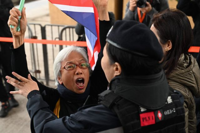 홍콩의 대표적인 반중 인사인 알렉산드라 웡이 18일 반중 매체 빈과일보 사주 지미 라이의 국가보안법 재판이 열리는 웨스트 카오룽 법원 앞에서 구호를 외치다 경찰 제지를 받고 있다. AFP연합뉴스