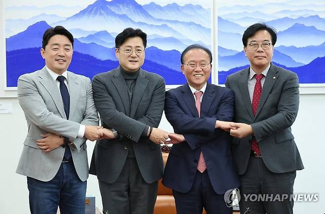 여야 예산안 2+2 협의체 첫 회의 (서울=연합뉴스) 이정훈 기자 = 여야 원내대표와 국회 예결위 여야 간사가 7일 국회 운영위원장실에서 열린 여야 예산안 2+2 협의체 회의에서 손을 맞잡고 기념촬영을 하고 있다. 왼쪽부터 더불어민주당 강훈식 의원, 홍익표 원내대표, 국민의힘 윤재옥 원내대표, 송언석 의원. 2023.12.7 uwg806@yna.co.kr (끝)