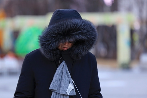 전국 대부분 지역에 한파특보가 발효된 22일 서울 광화문광장에서 두꺼운 옷을 입은 시민이 이동하고 있다. 연합뉴스