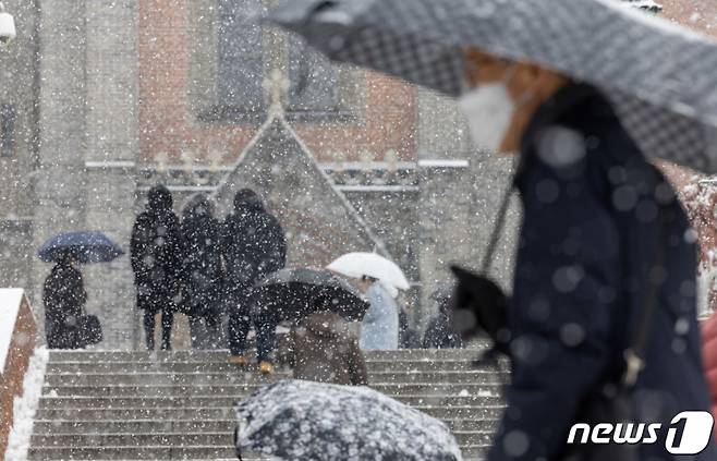 (서울=뉴스1) 이재명 기자 = 서울 전역에 대설주의보가 발효된 지난해 12월 30일 서울 중구 명동성당으로 시민들이 들어가고 있다. 2023.12.30/사진=뉴스1