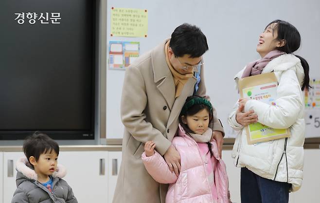 입학을 앞둔 어린이가 가족과 교실을 둘러보고 있다.