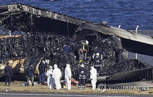 일본항공 여객기 잔해 조사 (도쿄 교도·AP=연합뉴스) 일본 조사관들이 4일 하네다공항에서 일본항공(JAL) 여객기 잔해를 살펴보고 있다.