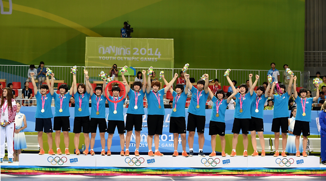 한국 여자 청소년 핸드볼대표팀이 지난 2014년 8월 25일, 중국 난징 지앙닝스포츠센터에서 열린 난징유스올림픽에서 러시아를 꺾고 우승을 차지한 뒤 시상식에서 금메달을 목에 걸고 기뻐하고 있다. 왼쪽에서 다섯번째 강경민 선수 모습이 보인다. 사진 | 대한체육회