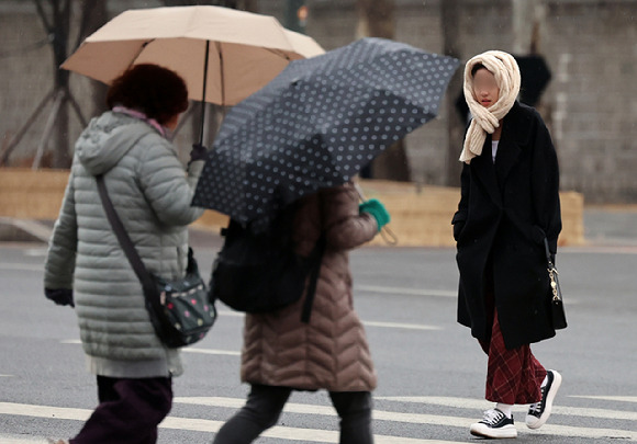 서울 중구 서울시청 인근에서 시민들이 우산을 쓰고 이동하고 있다. [사진=뉴시스]