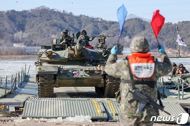 24일 오후 경기도 포천군 강포리 훈련장에서 열린 육군 제7공병여단과 수도기계화보병사단의 제병협동 도하훈련에서 K1A2 전차가 문교도하를 실시하고 있다. 2024.1.24/뉴스1 ⓒ News1 민경석 기자