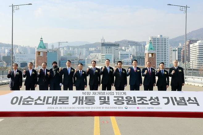 부산항만공사가 31일 부산항 북항 재개발 사업지 내 중구와 동구를 연결하는 이순신대로 개통 기념식을 개최한 가운데 관계자들이 기념촬영을 하고 있다. 사진제공ㅣ부산항만공사