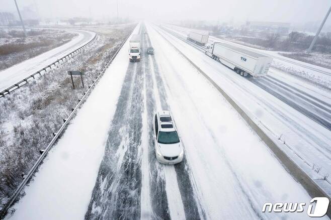 지난 2022년12월24일(현지시간) 캐내다 온타리오주 런던에 있는 한 고속도로에서 차량 운전자들이 눈 덮인 도로 위를 서행하고 있다. 2022.12.24. ⓒ AFP=뉴스1 ⓒ News1 김성식 기자