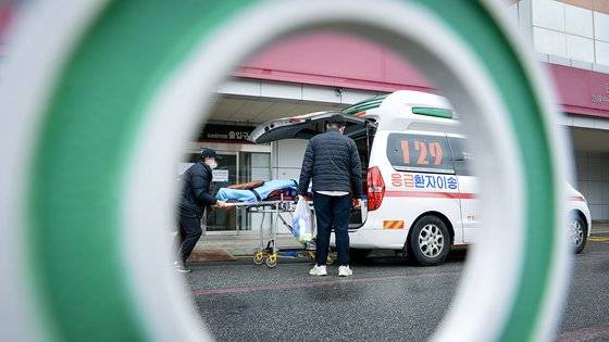 정부의 의대 증원에 반대하는 전공의들의 집단 이탈이 지속되면서 전국 의료 현장이 혼란을 빚고 있다. 지난 25일 대전의 한 대학병원 응급실 밖에서 한 대원이 환자를 구급차에 태우고 있다. 프리랜서 김성태