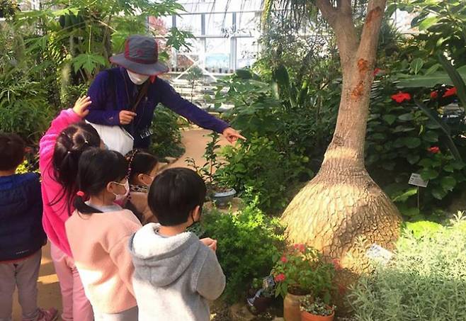 어린이들이 성남시 중원구 은행동에 있는 식물원 내 온실에서 열대 식물에 관한 설명을 듣고 있다. / 사진제공=성남시