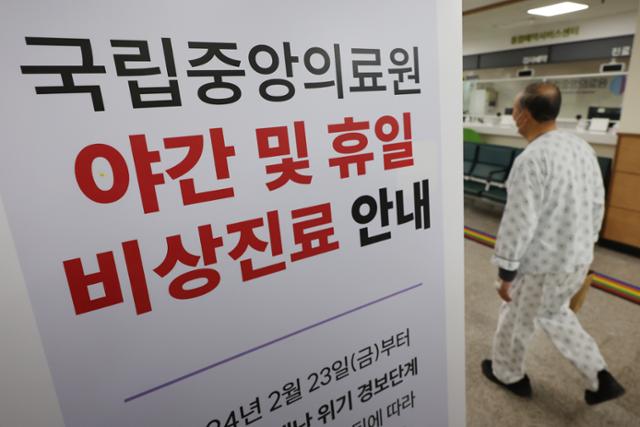 26일 오후 서울 중구 국립중앙의료원에 게시된 야간 및 휴일 비상진료 안내문 뒤편으로 환자가 걸음을 옮기고 있다. 뉴스1