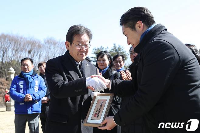 이재명 더불어민주당 대표가 3.1절인 1일 서울 용산구 효창공원 백범 김구 묘역에서 백범 김구 선생의 증손자인 김용만 대한민국 임시정부 기념사업회 이사로부터 친필 휘호를 받고 있다. 2024.3.1/뉴스1 ⓒ News1 이승배 기자