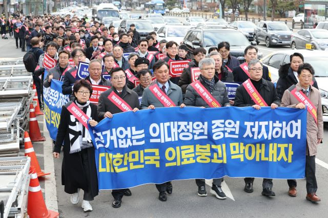 25일 오후 서울 용산구 대한의사협회에서 열린 '전국 의사 대표자 확대 회의 및 행진 행사'에서 참가자들이 대통령실 방향으로 행진하며 의대 정원 증원 반대 구호를 외치고 있다. 연합뉴스