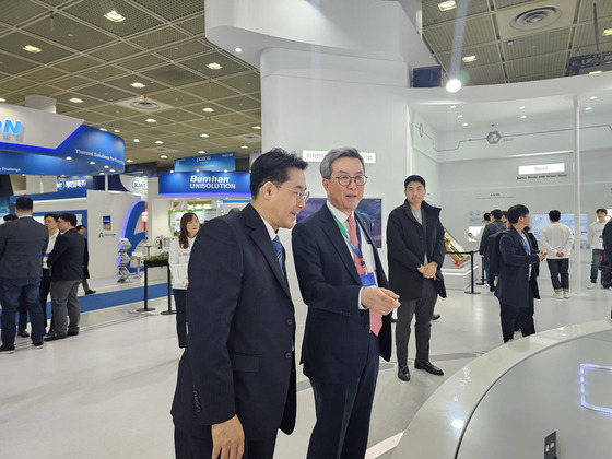 Kim Jun-hyung, second from left, head of the eco-friendly materials business at Posco Holdings, tours the company's booth at InterBattery 2024 held in Coex, southern Seoul on Wednesday. [JOINT PRESS CORPS]