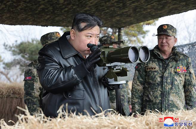 This photo, provided by North Korea's official Korean Central News Agency on Friday, shows North Korean leader Kim Jong-un watching a firing drill by the North Korean Army's front-line combined artillery units "who have put the enemy's capital in their striking range" on Thursday. (Yonhap)