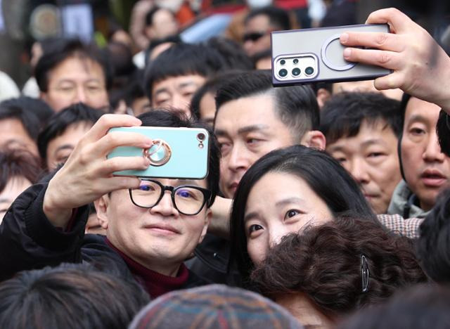 한동훈 국민의힘 비상대책위원장이 8일 오후 경기 용인시 기흥구 보정동카페거리에서 시민들과 셀카를 찍고 있다. 뉴시스