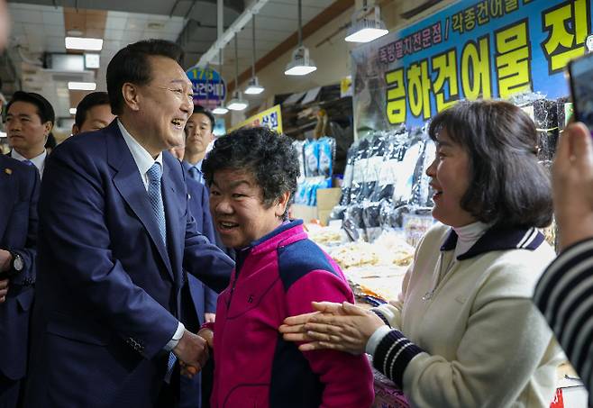 윤석열 대통령이 13일 경남 사천시 삼천포용궁수산시장을 찾아 상인, 주민들과 인사하고 있다. 연합뉴스