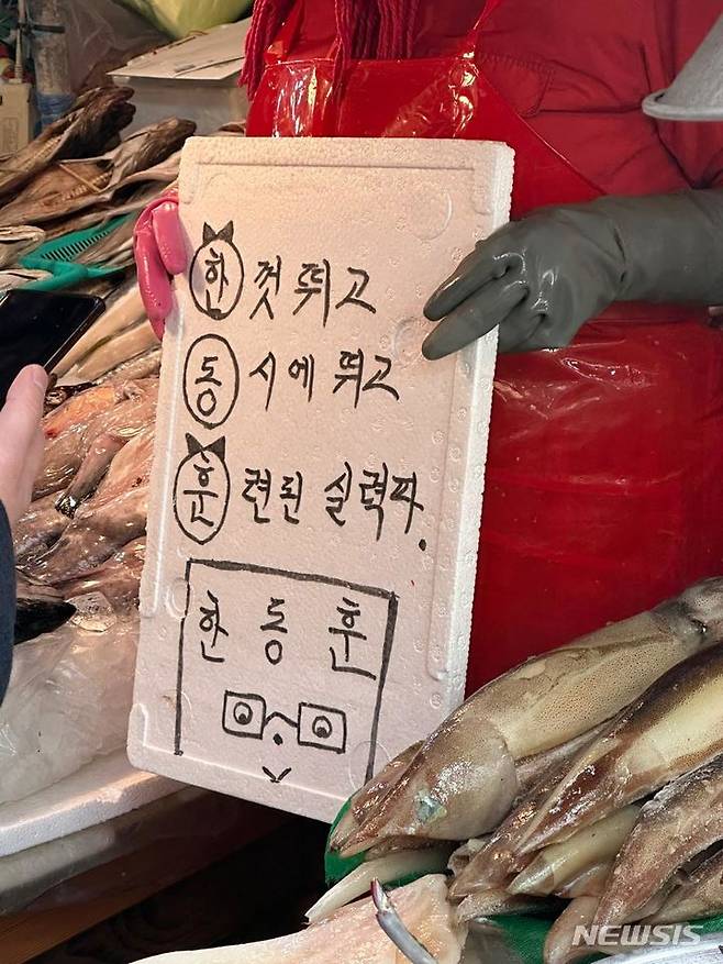 [부산=뉴시스] 하지현 기자= 14일 오후 부산 북구 구포시장 상인이 한동훈 국민의힘 비상대책위원장의 시장 방문을 환영하며 삼행시를 선보이고 있다. 2024.03.14. judyha@newsis.com