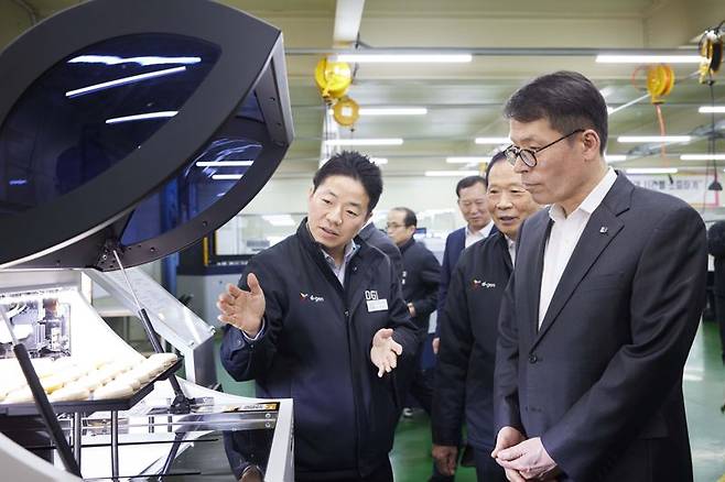 김성태 IBK기업은행장(오른쪽)이 지난 14일 경기도 양주시에 위치한 디지아이를 방문해 최동호 대표에게 작업공정에 관한 설명을 듣고 있다. IBK기업은행 제공