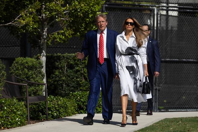 도널드 트럼프 전 미국 대통령이 아내 멜라니아와 함께 지난 19일 플로리다 팜 비치의 모튼 앤 바바라 맨델 레크레이션 센터에서 함께 걸어나오고 있다. /AFP 연합뉴스