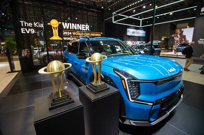 The Kia EV9 is displayed with the World Car of the Year and World Electric Vehicle of the Year trophies at the New York International Auto Show on Wednesday. (Hyundai Motor Group)