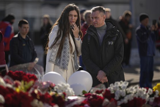 지난 22일(현지시간) 모스크바 공연장 테러로 숨진 이들을 위해 마련된 공간에서 시민들이 추모하고 있다. AP=연합뉴스