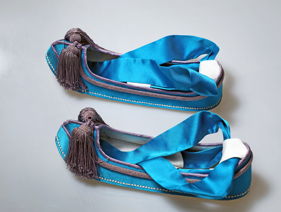 Reproduced version of the blue traditional Korean shoes that were once worn by crown princess of Korea Yi Bang-ja (1901-1989) [PARK SANG-MOON]