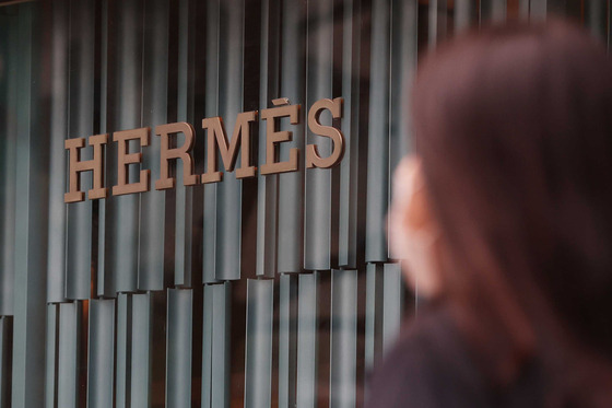 A person walks by a Hermes store in Seoul. [YONHAP]