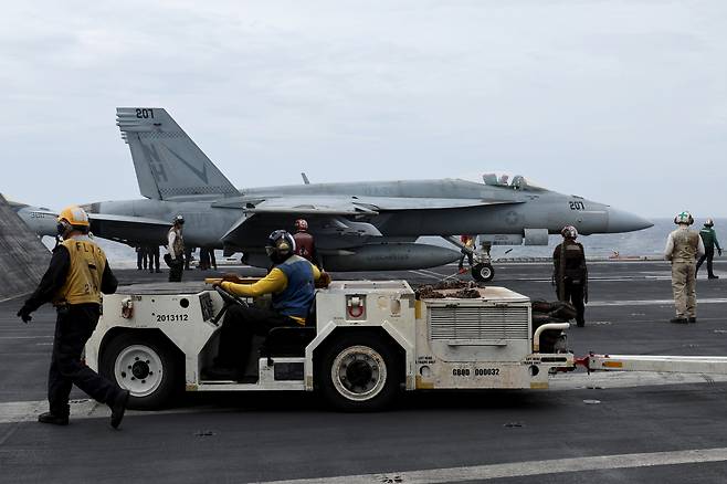 An F/A-18 Super Hornet fighter jet prepares to take off from the deck of the US nuclear-powered aircraft carrier Theodore Roosevelt during a trilateral naval exercise with South Korea and Japan in the high seas south of Jeju Island on Thursday. The US Navy invited reporters from the three countries aboard the carrier to see the fighter jet’s takeoff, landing drills as well as its interior.