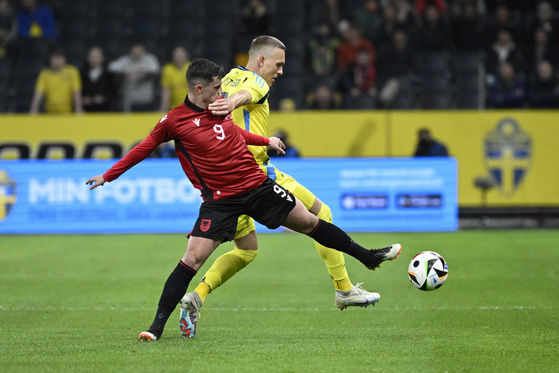 Albania's Jasir Asani, left, and Sweden's Ludwig Augustinsson in action during a friendly in Stockholm, Sweden on March 25. [EPA/YONHAP]