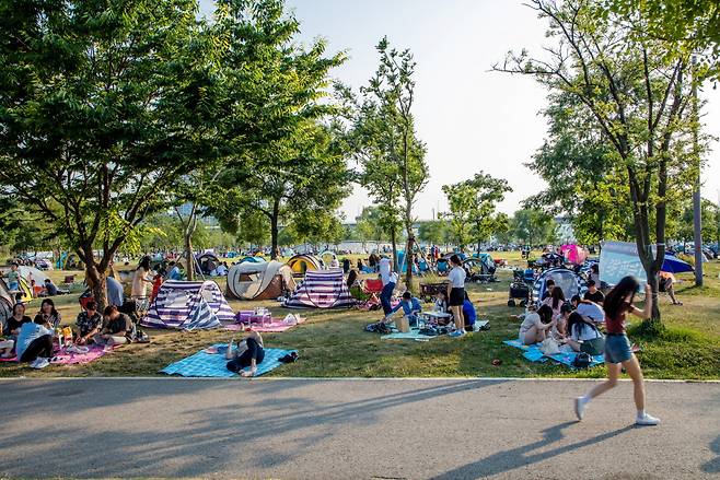 Picnickers relax in the park along the Han River in Seoul. (Korea Tourism Organization)