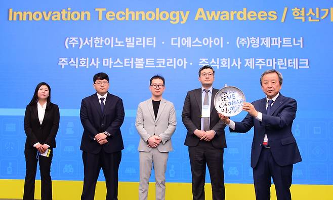김대환 국제e-모빌리티엑스포 이사장(오른쪽 첫번째)이 혁신기술상 수상 기업 관계자에게 상패를 전달하고 있다.