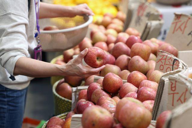 3일 오후 서울 시내 전통시장에서 시민이 사과를 고르고 있다. 뉴스1