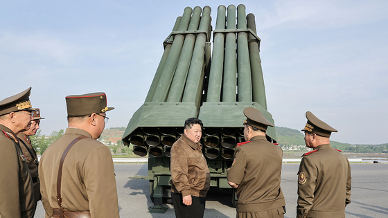 North Korean leader Kim Jong-un, center, inspects a test-fire of controllable shells for its 240-millimeter multiple rocket launchers on Friday, in a photo carried by its official Korean Central News Agency Saturday. [YONHAP]