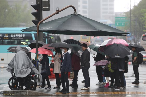 봄비가 내린 지난달 16일 오전 서울 종로구 세종대로 사거리에서 출근길 시민들이 우산을 쓰고 있다. 뉴스1