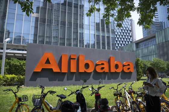 A person parks her bicycle in front of Alibaba's offices in Beijing, China. [AP/YONHAP]