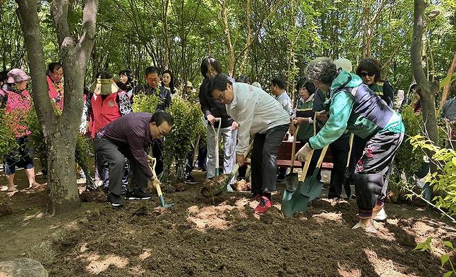 '맨발의 동작' 프로젝트 박일하 동작구청장(가운데 흰색 옷)이 지난 16일 서달산 등산로 내에서 열린 '맨발의 동작' 프로젝트 행사에서 주민들과 흙길 일대를 정비하고 있다. [동작구 제공. 재판매 및 DB 금지]