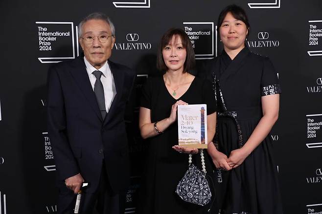 From left, South Korean author Hwang Sok-yong, translators Sora Kim-Russell and Youngjae Josephine Bae pose on the red carpet upon arrival for the 2024 International Booker Prize ceremony, at Tate Modern in central London, on Tuesday. (Yonhap)