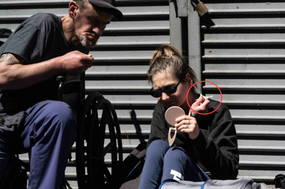 한 여성이 목에 주사기를 꽃은 채 마약을 투약하고 있다. 이곳에선 길거리마다 흔하게 볼 수 있는 장면이다.