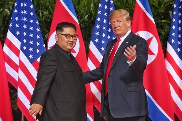 2018년 6월 12일 싱가포르에서 열린 정상회담 직전 기념촬영하는 김정은(왼쪽) 북한 국무위원장과 도널드 트럼프 미국 당시 대통령. 싱가포르 통신정보부·연합뉴스