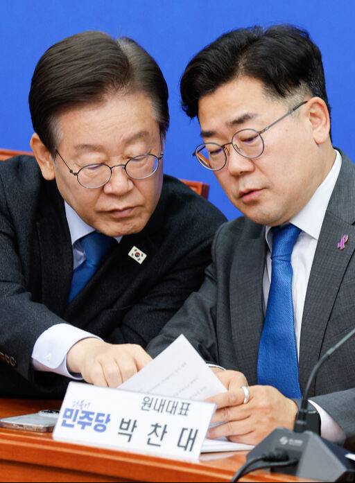 더불어민주당 이재명 대표와 박찬대 원내대표가 29일 서울 여의도 국회에서 열린 최고위원회의에서 대화를 나누고 있다. 뉴스1 