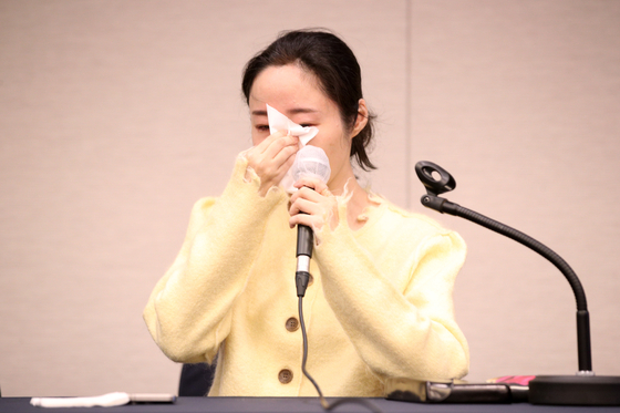 ADOR CEO Min Hee-jin sheds tears during Friday's press conference. [JOINT PRESS CORPS]