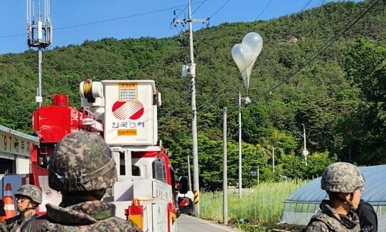 지난 29일 오전 전북 무주군 무주읍의 한 마을에서 북한이 날려 보낸 것으로 추정되는 풍선이 전선에 걸린 채 발견돼 군과 경찰이 내용물을 조사하고 있다. 연합뉴스