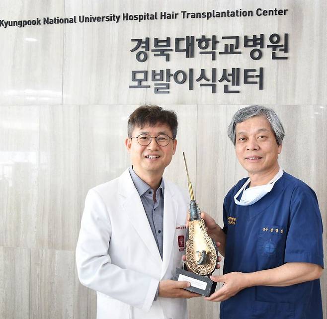 30일 별세한 김정철 전 경북대병원 모발이식센터장(오른쪽)과 제자인 김문규 경북대병원 모발이식센터 교수. 2020년 김문규 교수가 백금모낭상 수상했을 당시 기쁨을 나누고 있다./경북대병원.