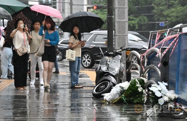 역주행 차량이 인도를 덮쳐 13명의 사상자가 난 2일 서울 중구 시청역 인근에 사고로 파손된 오토바이와 희생자를 위한 국화가 놓여 있다. 윤웅 기자