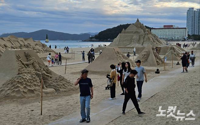 부산 해운대해수욕장에 설치된 모래 작품 앞에서 시민들이 사진을 찍고 있다. 김혜민 기자