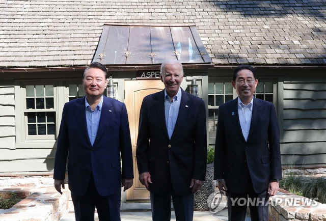 윤석열 대통령과 조 바이든 미국 대통령, 기시다 후미오 일본 총리가 지난해 8월18일(현지시간) 워싱턴DC 인근 미국 대통령 별장인 캠프 데이비드에서 열린 한미일 정상회의 일정을 마치고 대통령 전용 숙소인 '아스펜' 앞에서 기념촬영을 하고 있다. 연합뉴스