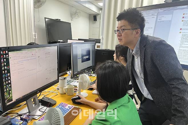 지난달 25일 폴리텍 서울강서캠퍼스 스마트금융과 김효관(오른쪽) 교수가 학생들이 수행한 프로젝트를 살펴보고 있다.(사진=서대웅 기자)