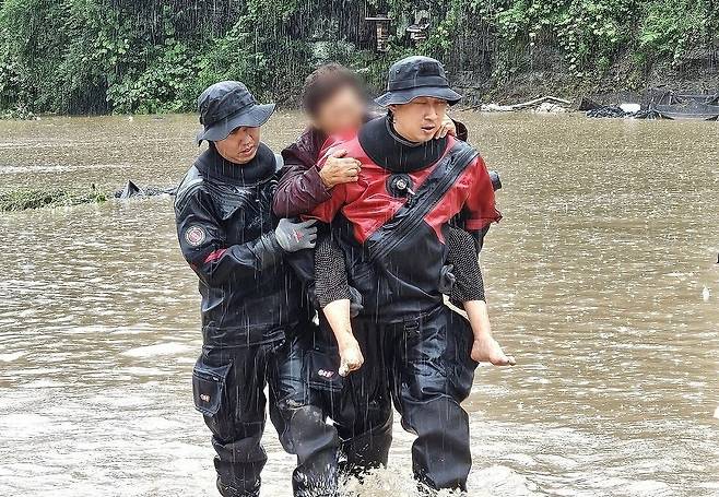 집중호우로 침수된 마을서 구조되는 주민 (안동=연합뉴스) 8일 오전 경북 안동시 임동면 대곡리 한 마을이 집중호우로 침수된 가운데 소방 관계자가 침수된 마을에서 주민을 구조하고 있다. 2024.7.8 [경북소방본부 제공.재판매 및 DB금지] psik@yna.co.kr